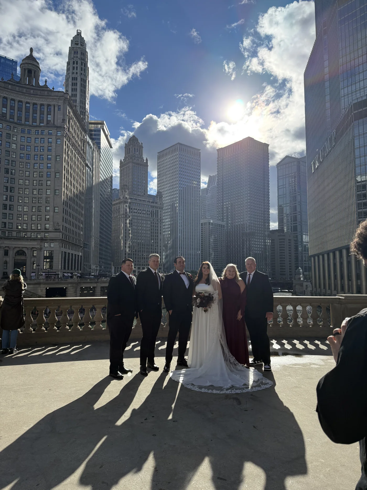 Noah and his family with the bride and groom at his sister’s wedding, with the Chicago skyline behind them.